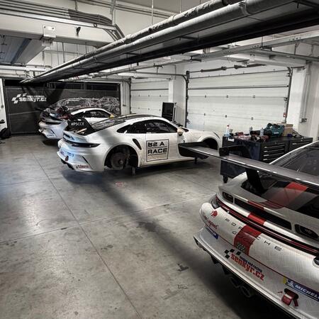 Our four Porsche 992 GT3 Cup race cars in the pits at the...