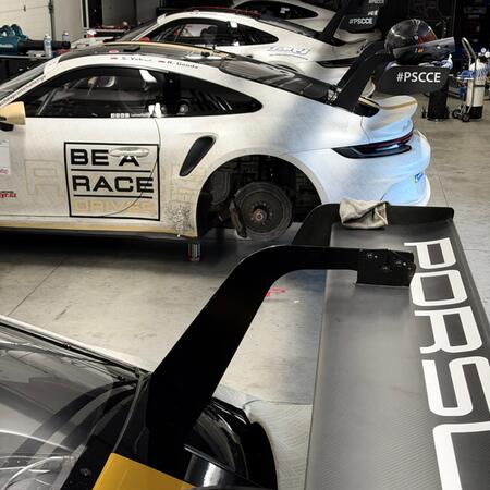 Our four Porsche 992 GT3 Cup race cars in the pits at the...