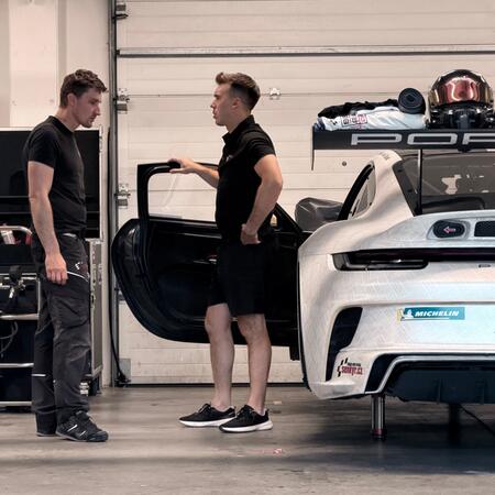 R. Gonda is consulting with a technician in the pits about...
