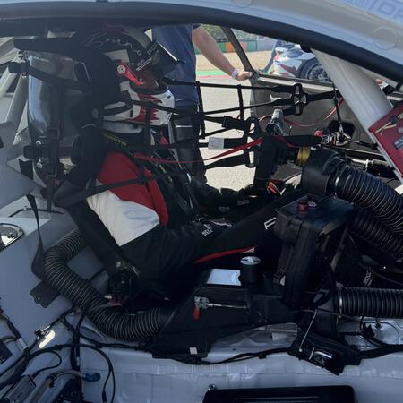L. Schmied at the wheel of a BMW M4 GT4 racing car