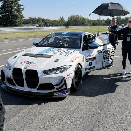 L. Schmied at the wheel of a BMW M4 GT4 racing car