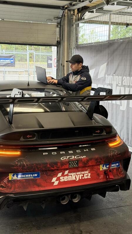 Coach Erik Janiš checks the setup of the Porsche 992 GT3...