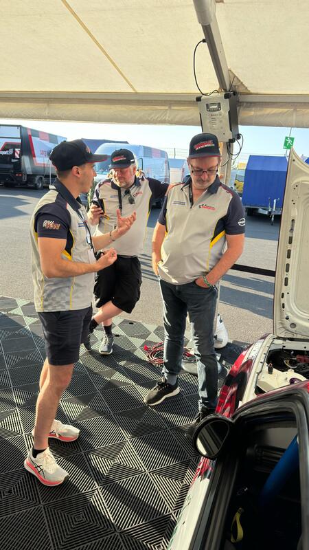 The team from car number 464 are inspecting the engine of...
